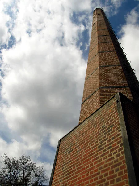 Over a century old brick chimney against the sky — Stock Photo, Image