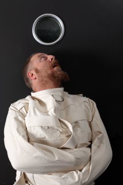 Paranoid man in a straitjacket clipart