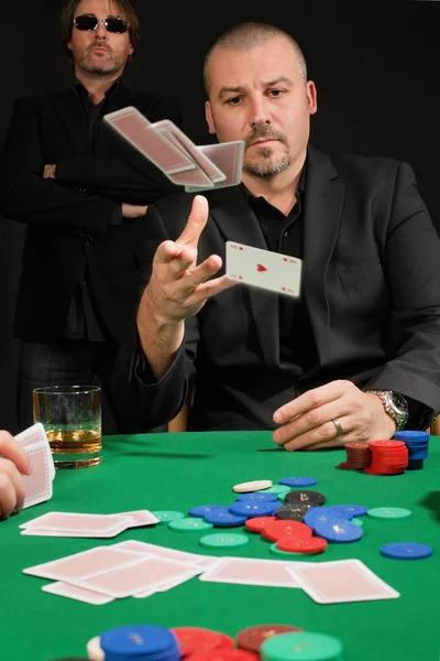 Card player throwing in his hand — Stock Photo, Image