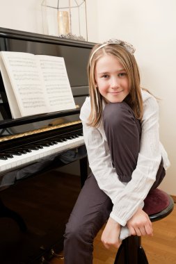 Young girl and her piano clipart