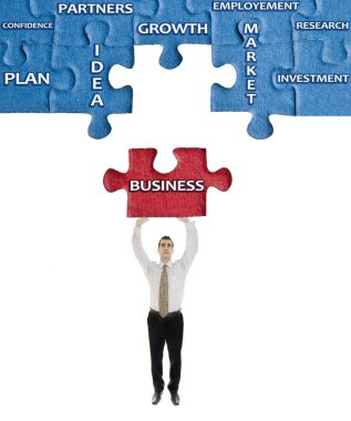 Business word on puzzle in man hands clipart