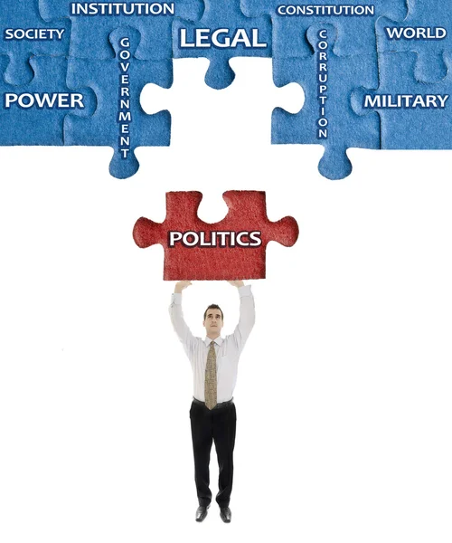 Politiek woord op puzzel in handen van de mens — Stockfoto