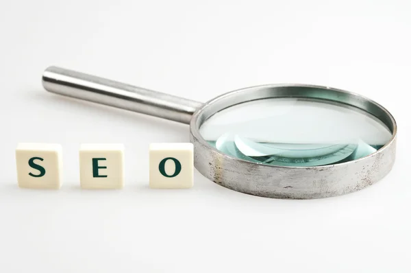 SEO word and magnifying glass — Stock Photo, Image