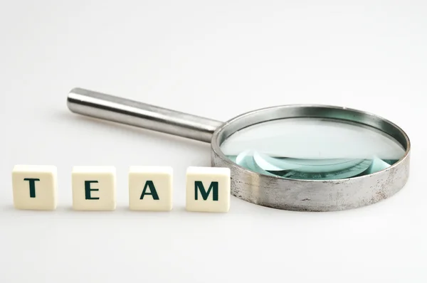 Team word and magnifying glass — Stock Photo, Image