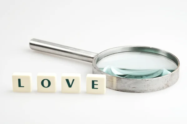 Love word and magnifying glass — Stock Photo, Image