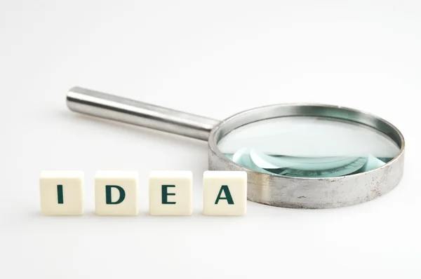 Idea word and magnifying glass — Stock Photo, Image