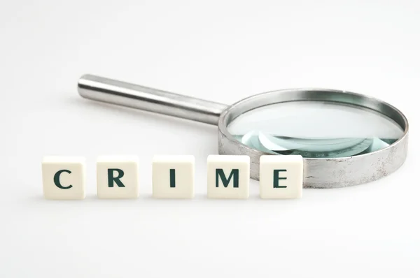 Crime word and magnifying glass — Stock Photo, Image