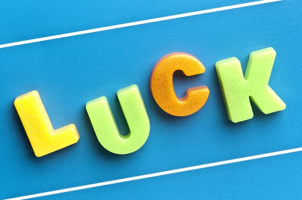 Palavra da sorte no tabuleiro azul — Fotografia de Stock