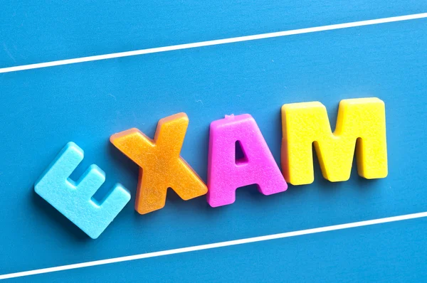 Exam word on blue board — Stock Photo, Image