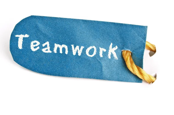 Palabra de trabajo en equipo en la etiqueta —  Fotos de Stock