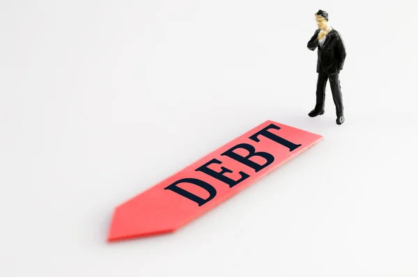 Debt direction and toy business man — Stock Photo, Image