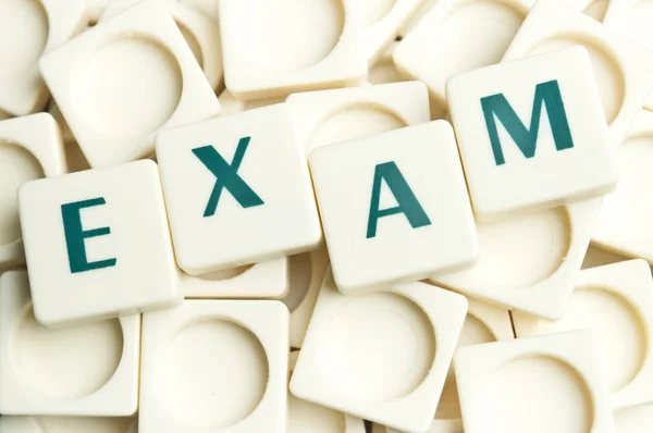 Exam word made by leter pieces — Stock Photo, Image