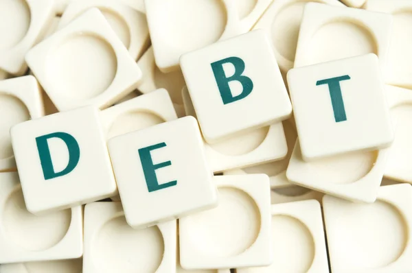 Palabra de deuda hecha por piezas de letras — Foto de Stock