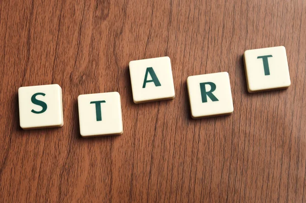 Start word made by letter pieces — Stock Photo, Image