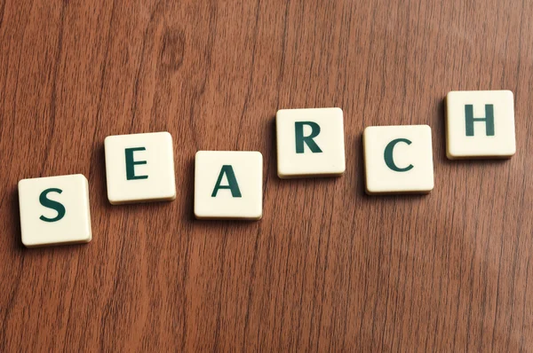 Search word made by letter pieces — Stock Photo, Image