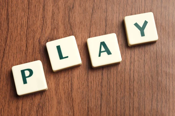 Play word made by letter pieces — Stock Photo, Image