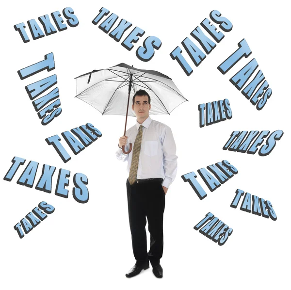 Taxes word and business man with umbrella — Stock Photo, Image
