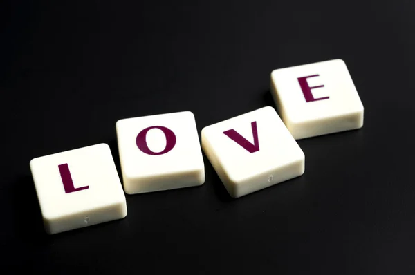Love word made by letter pieces — Stock Photo, Image