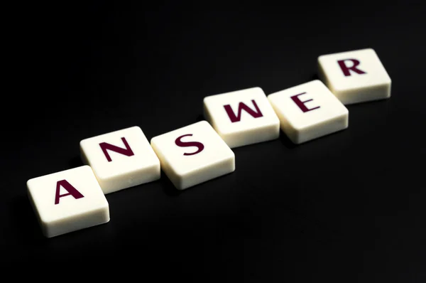 Answer word made by letter pieces — Stock Photo, Image