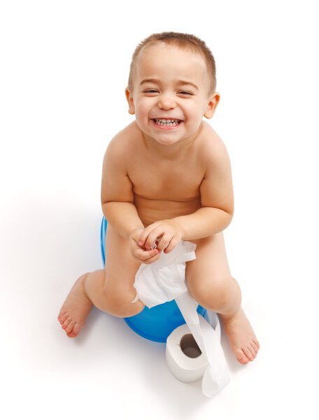 Laughing little boy sitting on potty