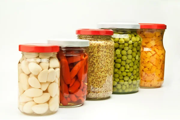 Five jars of preserved food Royalty Free Stock Images