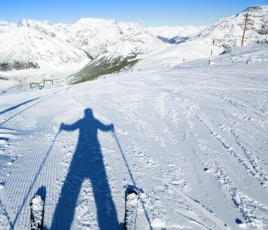 A shadow of ready to go downhill skier clipart