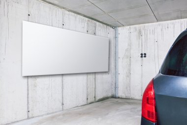 Blank white advertisement board on the wall in parking clipart