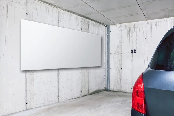 Placa de publicidade branca em branco na parede no estacionamento — Fotografia de Stock