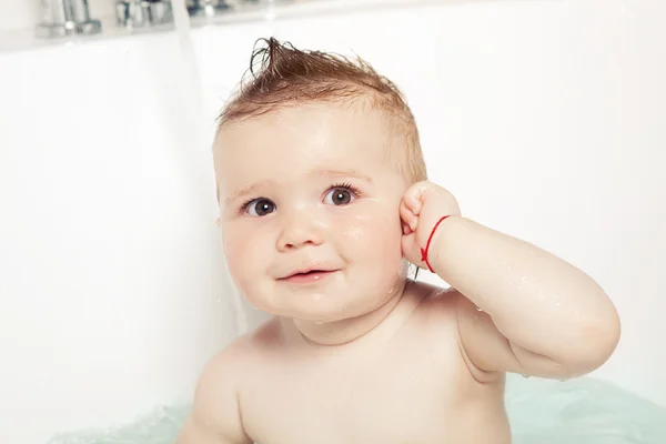 Cute baby showing "where the ear is" and smiling while taking a bath — Stock Photo, Image