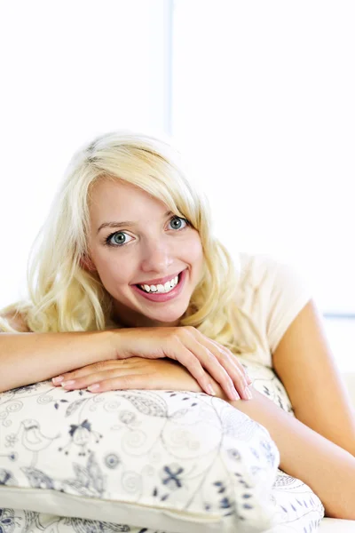 Happy woman on couch at home Royalty Free Stock Photos