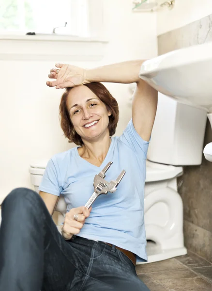 Vrouw tot vaststelling van sanitair — Stockfoto