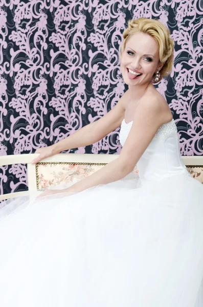 Smiling bride put out her toungue sitting bench — Stock Photo, Image