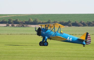 Boeing Stearman taxis after landing clipart