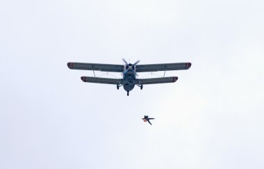 Skydiver jumps from An-2 biplane clipart
