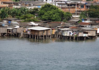 Poor houses built out over the water in brazil clipart