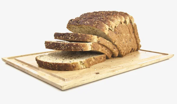 Seeded bread - sliced on wooden board — Stock Photo, Image