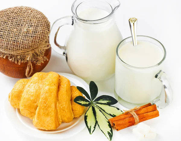 stock image Fresh milk in the jug and cup and croissant