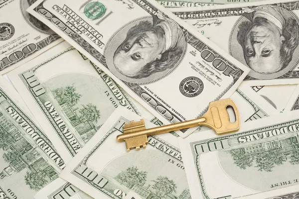 Golden key on money background — Stock Photo, Image
