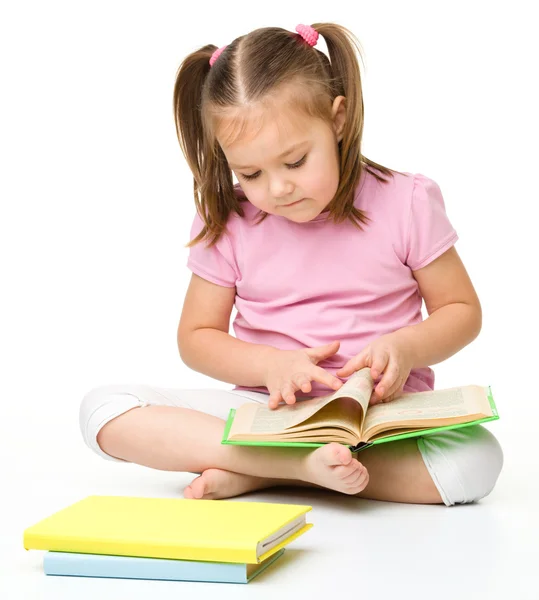 Cute little girl reads a book — Stock Photo, Image