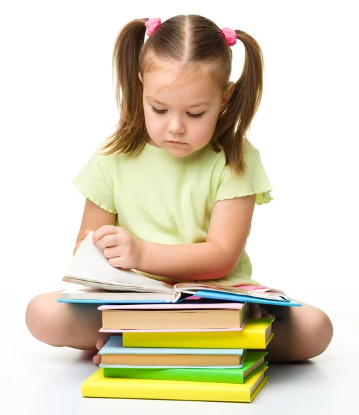 Cute little girl reads a book Royalty Free Stock Photos