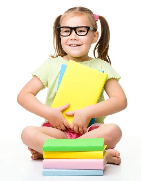 Милая маленькая девочка с книгами — стоковое фото