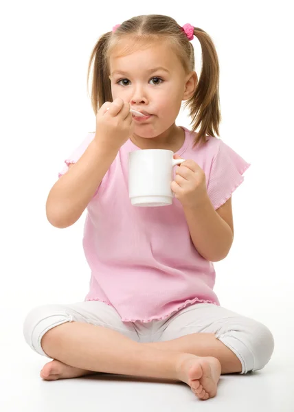 Cute little girl is eating — Stock Photo, Image