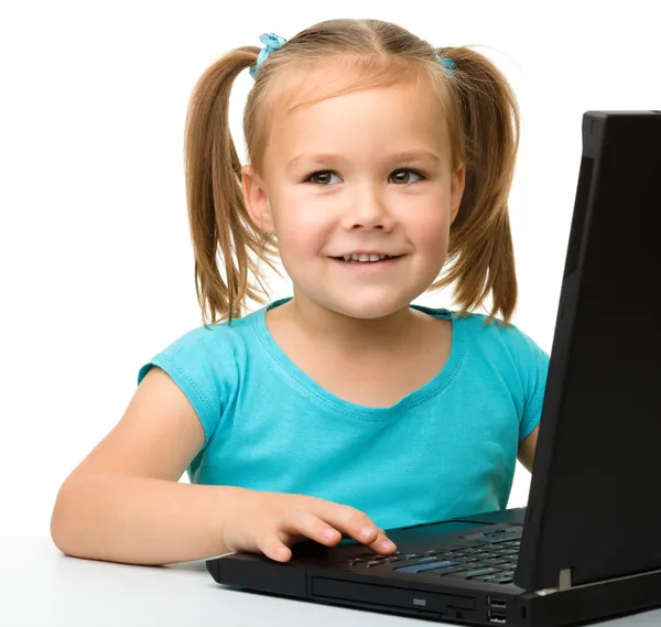 Little girl with laptop Stock Picture