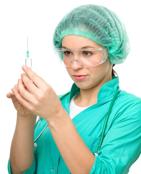 Young nurse is preparing syringe for injection Stock Photo
