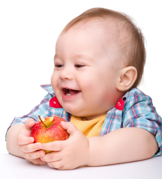 Criança está comendo maçã vermelha e sorriso — Fotografia de Stock