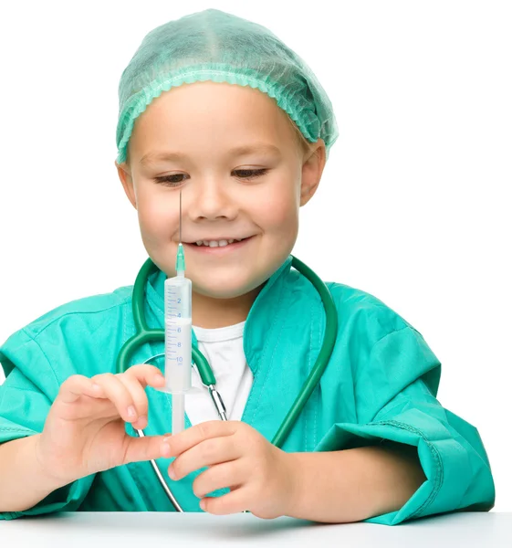 Holčička hraje doktora s injekční stříkačkou — Stock fotografie