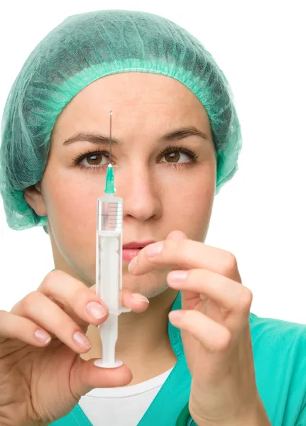 Young nurse is preparing syringe for injection — Stock Photo, Image