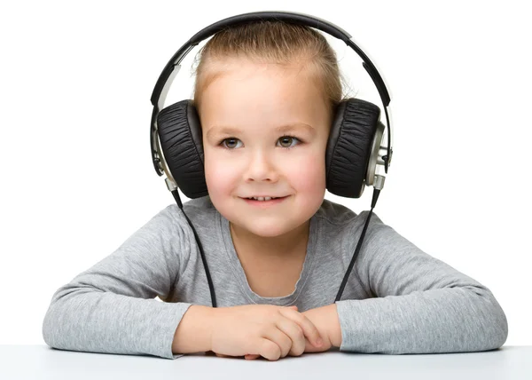 Cute girl enjoying music using headphones — Stock Photo, Image