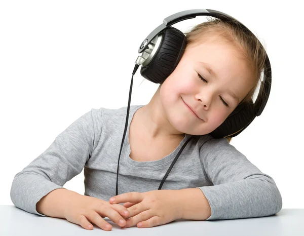 Menina bonito desfrutar de música usando fones de ouvido — Fotografia de Stock