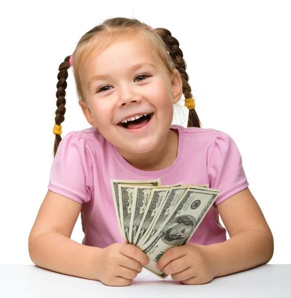 Niedliches kleines Mädchen mit Papiergeld - Dollars — Stockfoto
